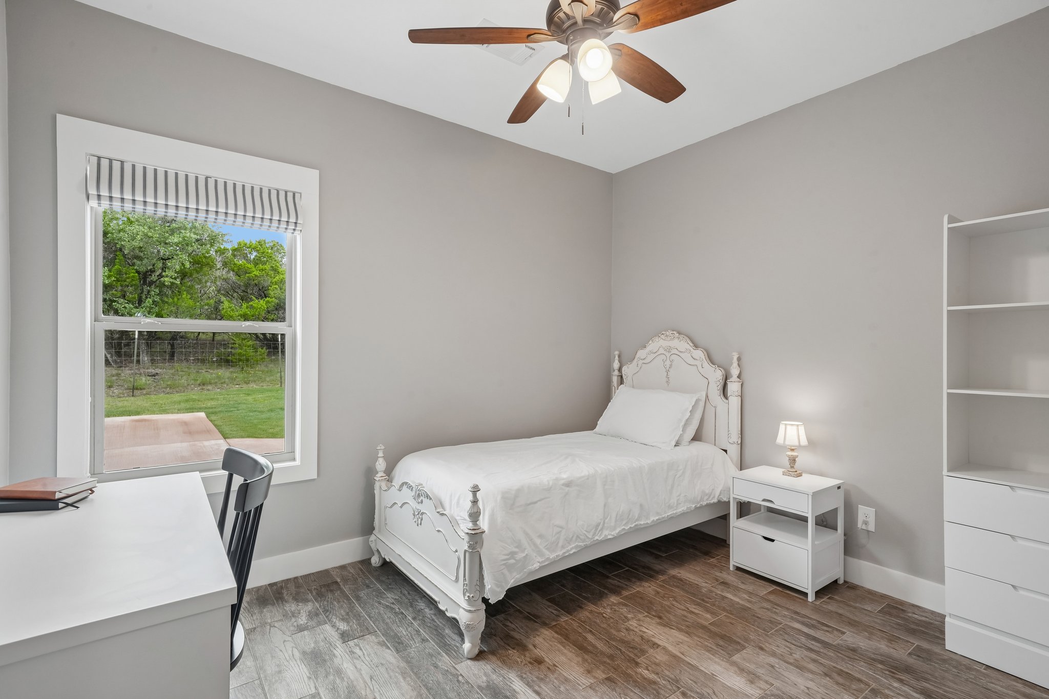 190 Magnolia Meadow Spring Branch, TX 78070 - Photo 13 of 29 Wood-look flooring and a window with verdant views define this pleasant room.
