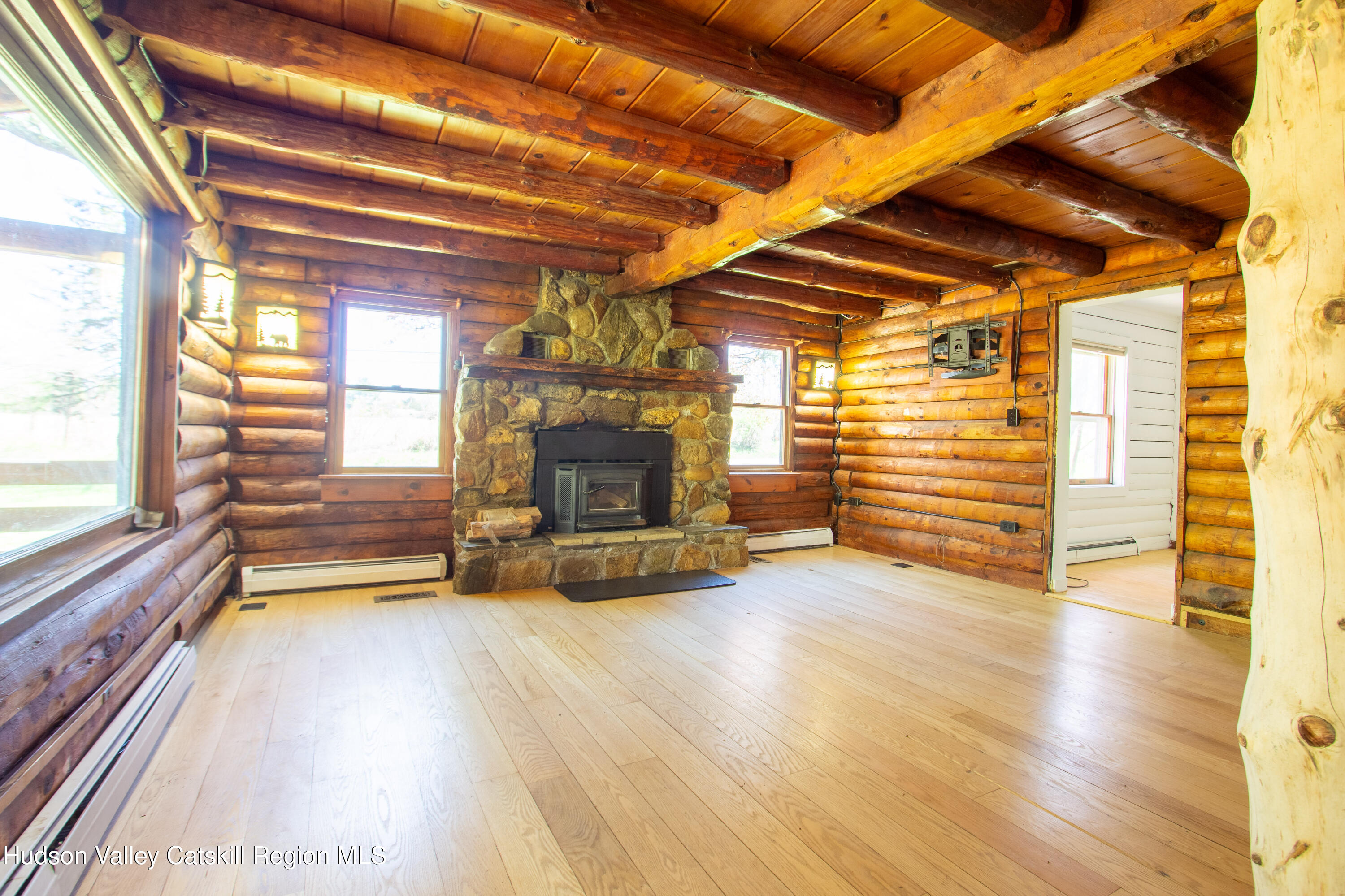 205 Fordham Road Valatie, NY 12184 - Photo 3 of 18 a view of empty room with wooden floor and fireplace