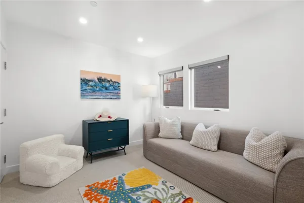 a living room with furniture and a baby crib