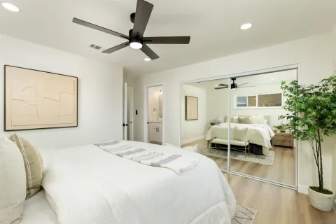a bedroom with a bed and a chandelier