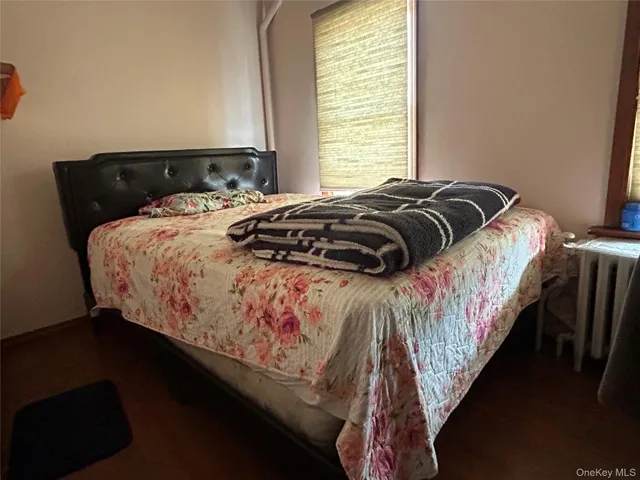 a bed sitting in a bedroom next to a window