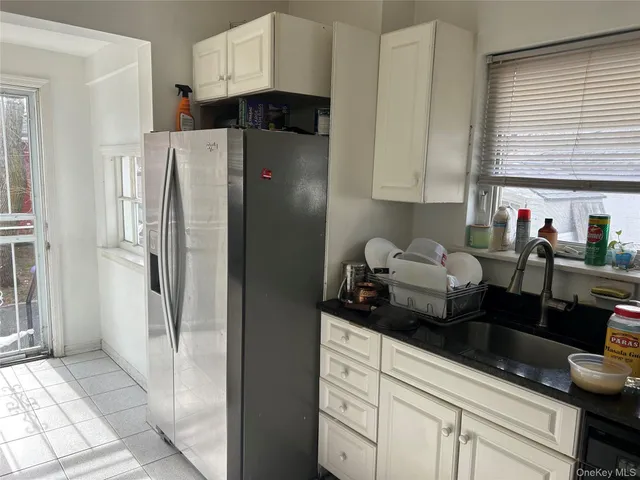 a kitchen with refrigerator and cabinets