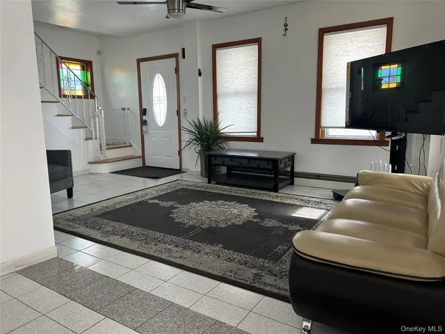 a living room with furniture and a flat screen tv