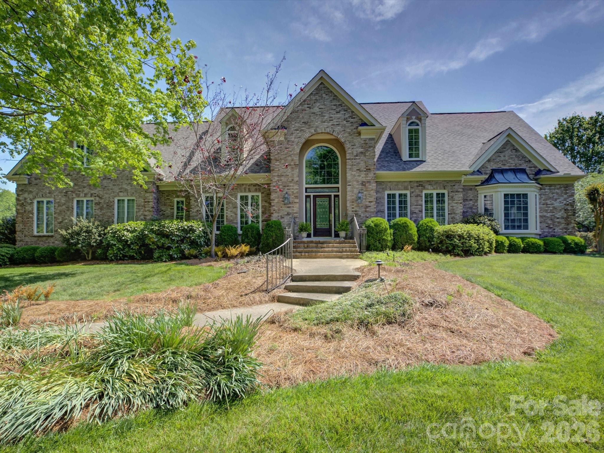 a front view of a house with a garden