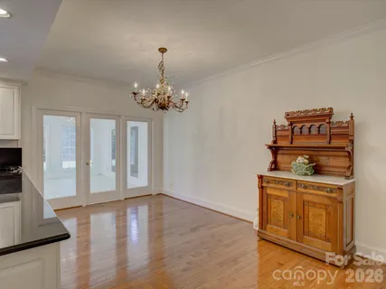 a view of a room with wooden floor cabinets and entryway