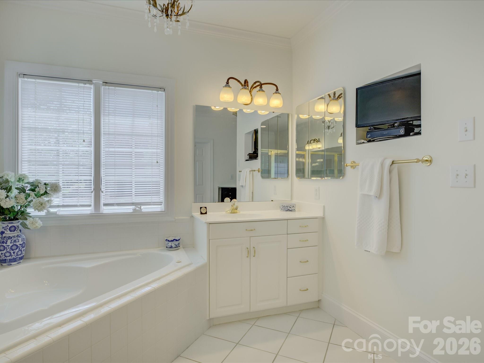 2980 Robinwood Road Gastonia, NC 28054 - Photo 23 of 48 a bathroom with a double vanity sink a mirror a window and a bathtub