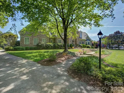 a front view of a house with yard and green space