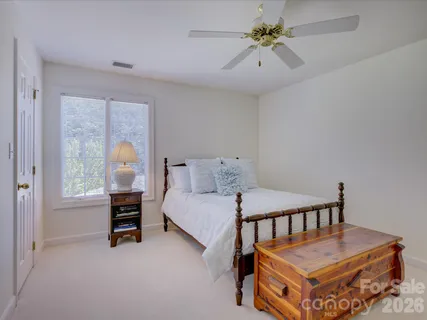 a bed room with furniture and a chandelier