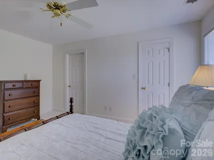 a view of a bedroom with a bed and a dresser