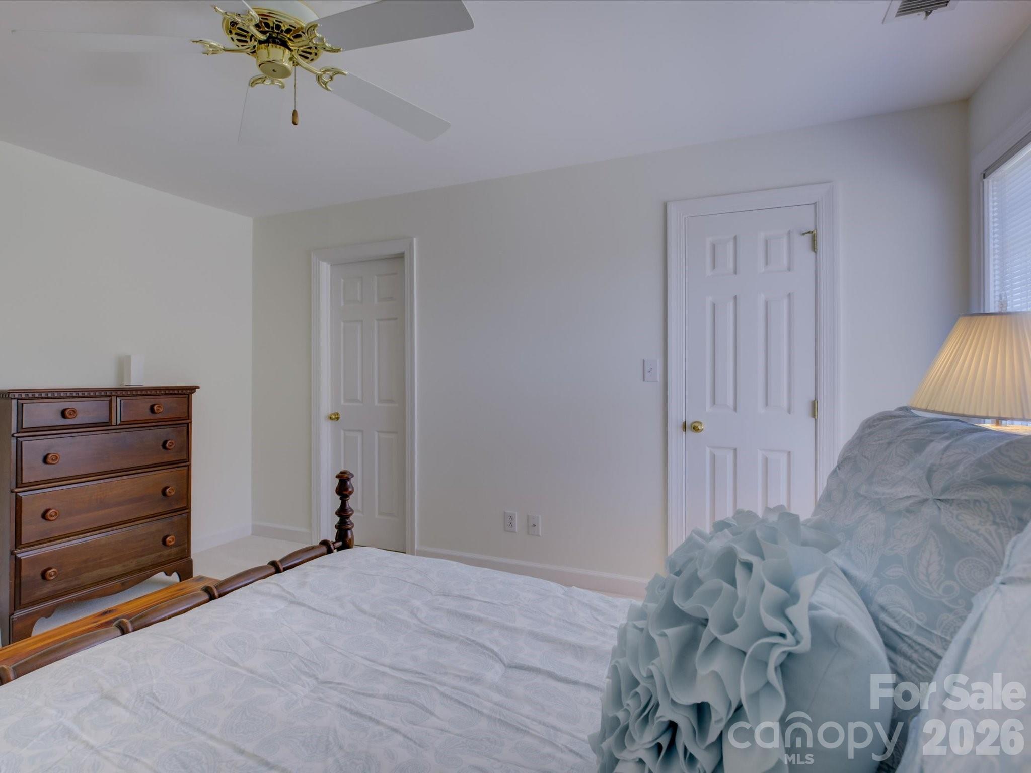 2980 Robinwood Road Gastonia, NC 28054 - Photo 35 of 48 a view of a bedroom with a bed and a dresser