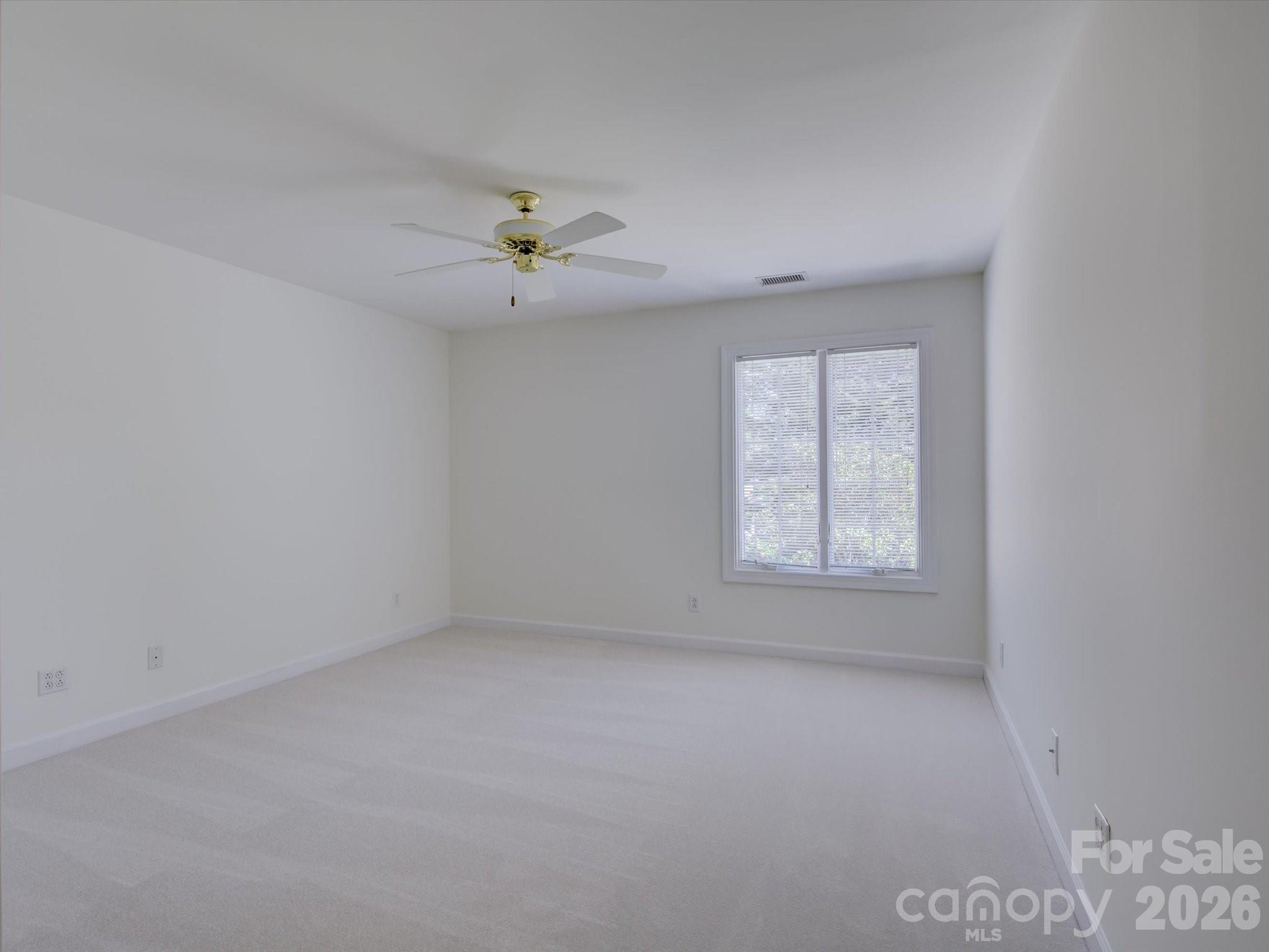 2980 Robinwood Road Gastonia, NC 28054 - Photo 38 of 48 an empty room with a window and a ceiling fan