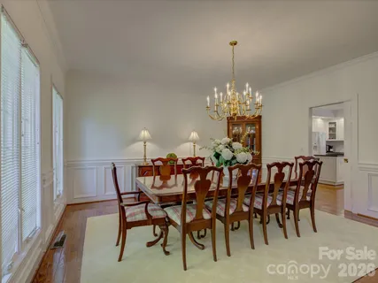 a view of a dining room with furniture and chandelier