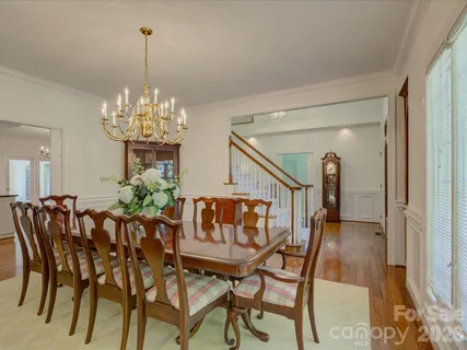 a view of a dining room with furniture and chandelier
