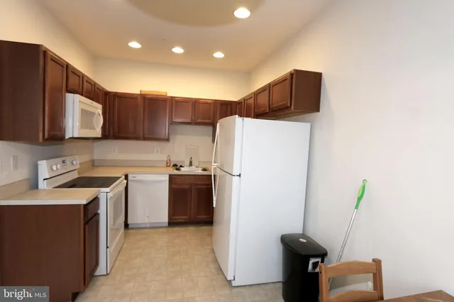 a kitchen with a refrigerator sink and stove