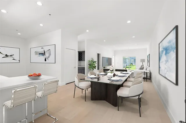a dining room with wooden floor and white furniture