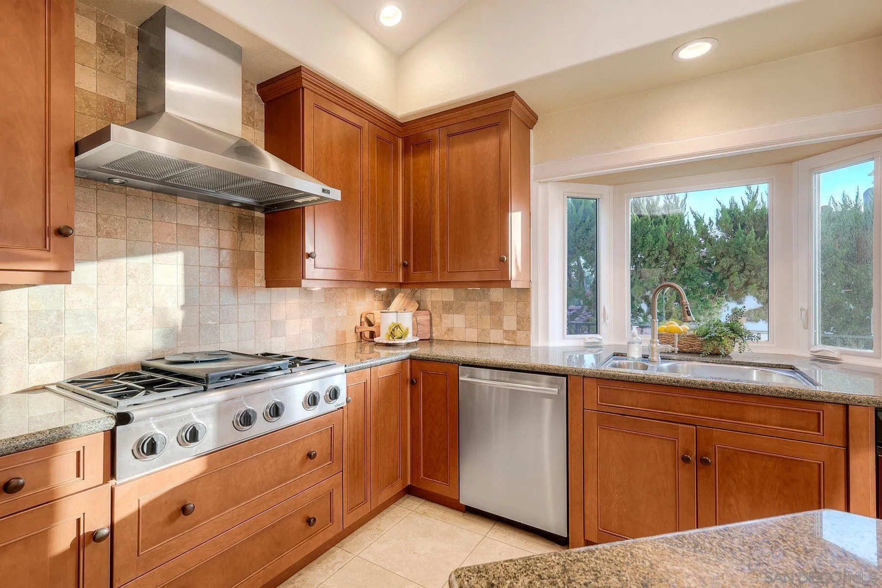 14036 Tierra Bonita Road Poway, CA 92064 - Photo 14 of 57 a kitchen with granite countertop a sink a stove and cabinets