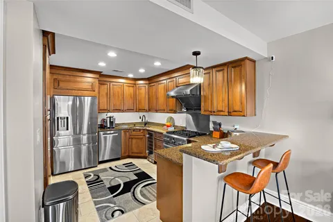a kitchen with a sink stove and refrigerator