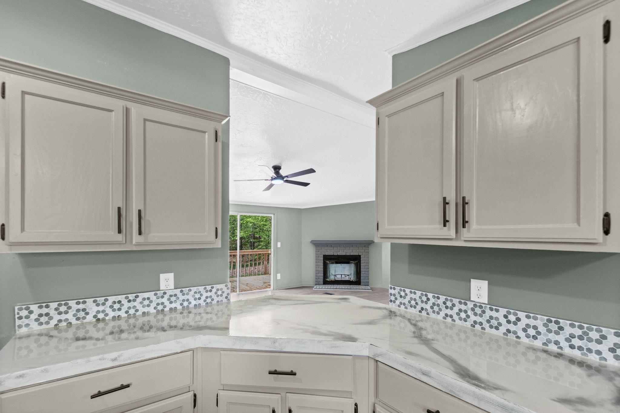 145 Walnut Bend Road Arlington, TN 38002 - Photo 12 of 30 a kitchen with granite countertop a white cabinets and a fireplace