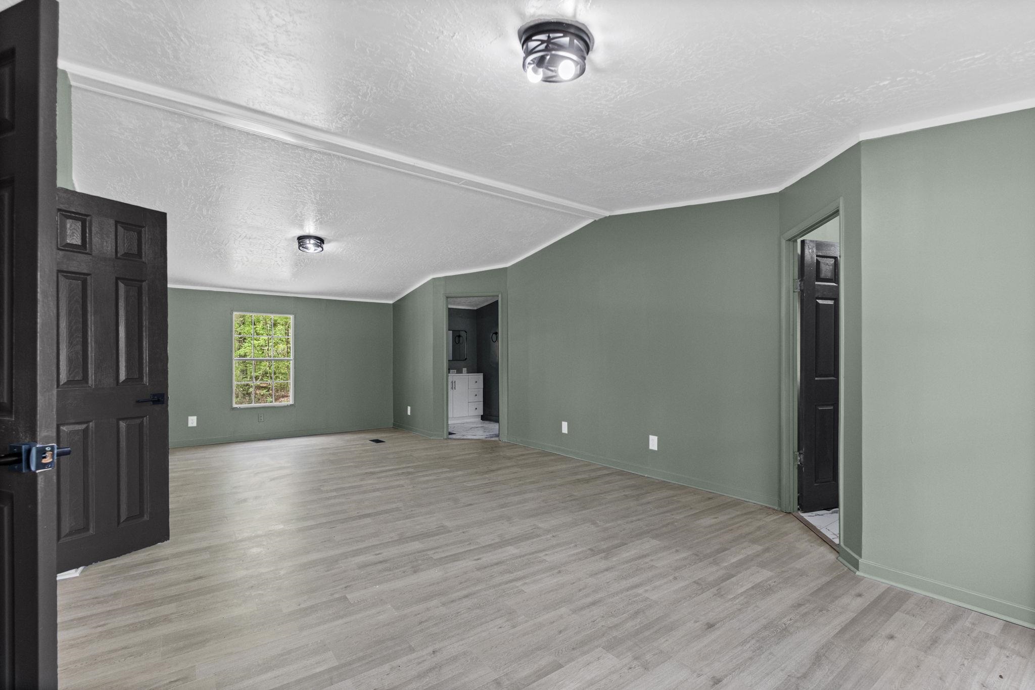 145 Walnut Bend Road Arlington, TN 38002 - Photo 13 of 30 a view of an empty room with wooden floor and a window