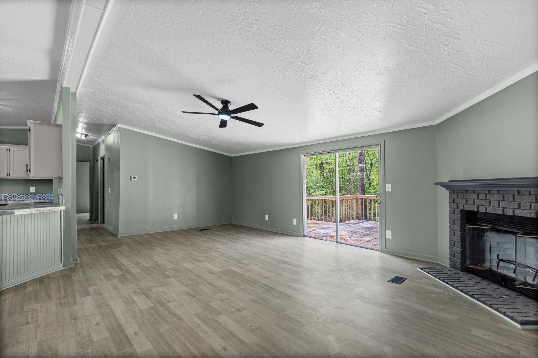 145 Walnut Bend Road Arlington, TN 38002 - Photo 4 of 30 a view of an empty room with a fireplace and a window