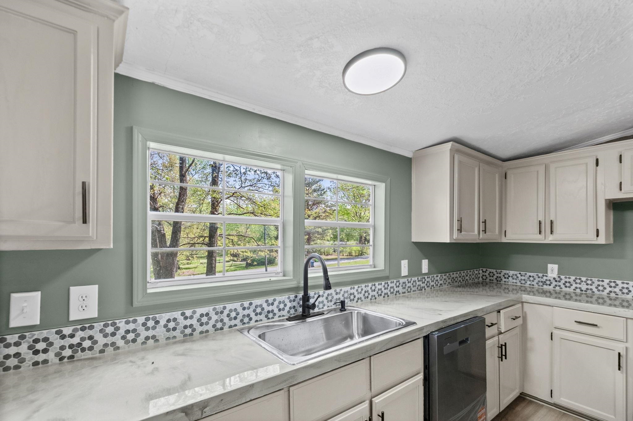 145 Walnut Bend Road Arlington, TN 38002 - Photo 8 of 30 a kitchen with a sink cabinets and window