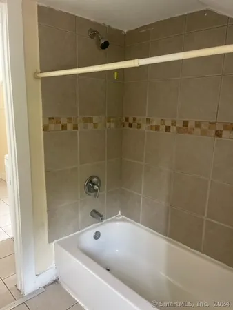 a bath tub sitting next to a shower