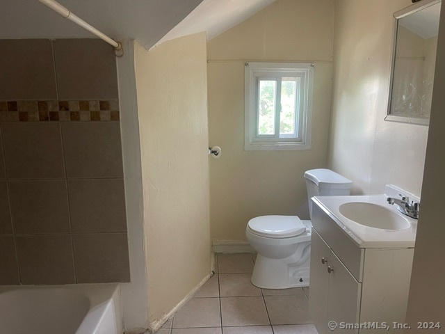 24 Arthur Street New Haven, CT 06519 - Photo 7 of 14 a white toilet sitting next to a bathroom sink and vanity