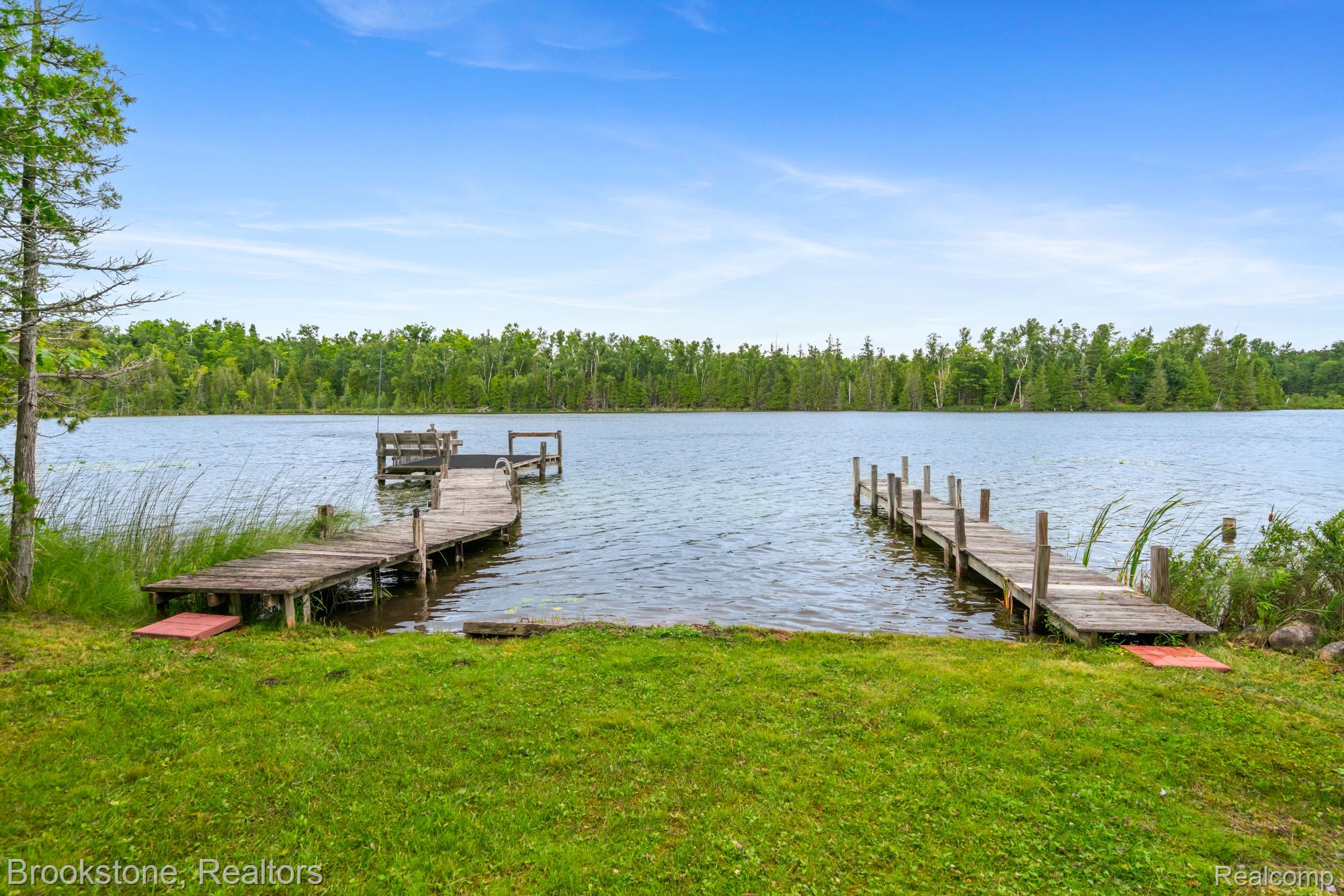 5699 Smith Road Cheboygan, MI 49721 - Photo 18 of 30 Waterfront property featuring two wooden docks extending into a lake