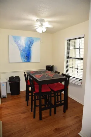 a dining room with furniture a rug and wooden floor