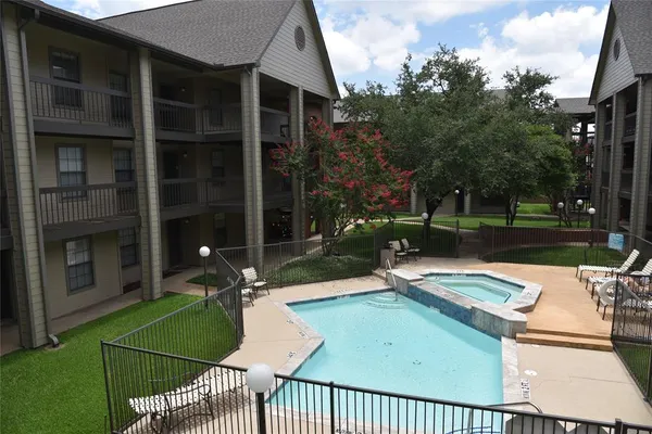front view of a house with a yard and trees