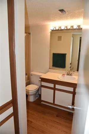 a bathroom with a toilet a sink and mirror