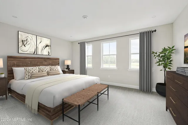 a bedroom with a bed and a potted plant