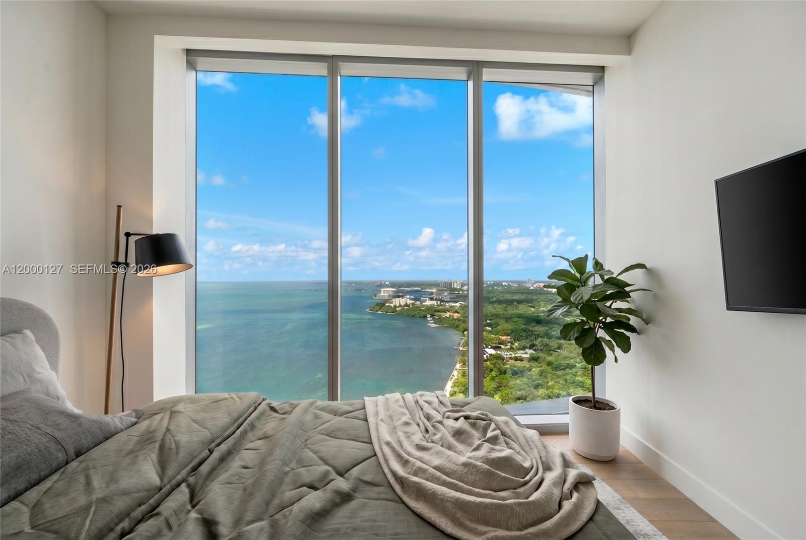 175 Southeast 25th Road, Unit 3602 Miami, FL 33129 - Photo 12 of 26 a bedroom with a bed and a potted plant