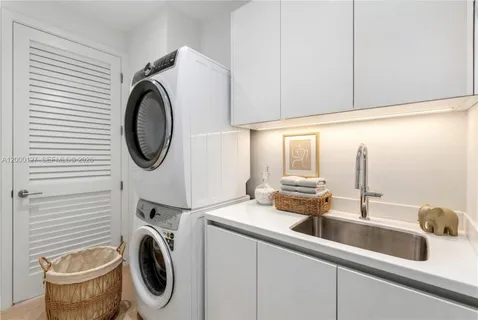 a kitchen with a sink and a washer dryer