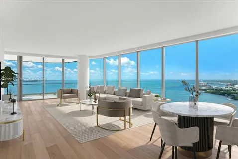 a living room with furniture and floor to ceiling windows