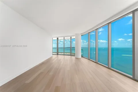 a view of an empty room with glass door