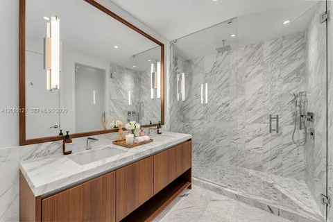a bathroom with a sink double vanity and a mirror