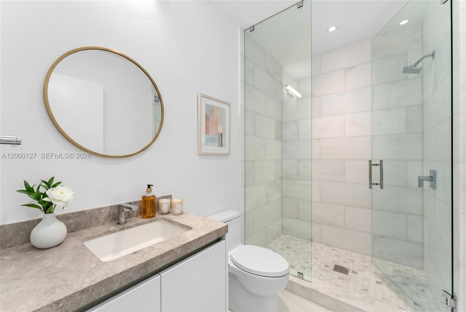 175 Southeast 25th Road, Unit 3602 Miami, FL 33129 - Photo 10 of 26 a bathroom with a granite countertop sink a toilet and a mirror