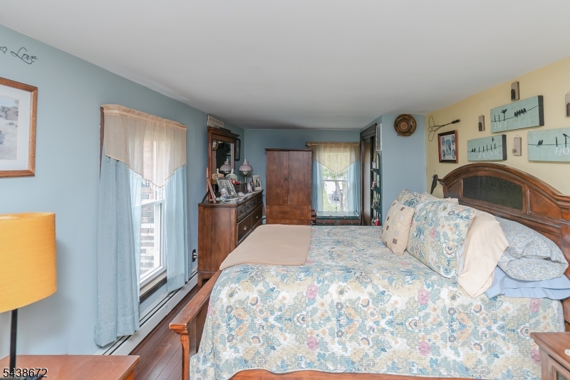 36 Main Street Flanders, NJ 07836 - Photo 20 of 31 a bedroom with a bed and a large mirror on the dresser