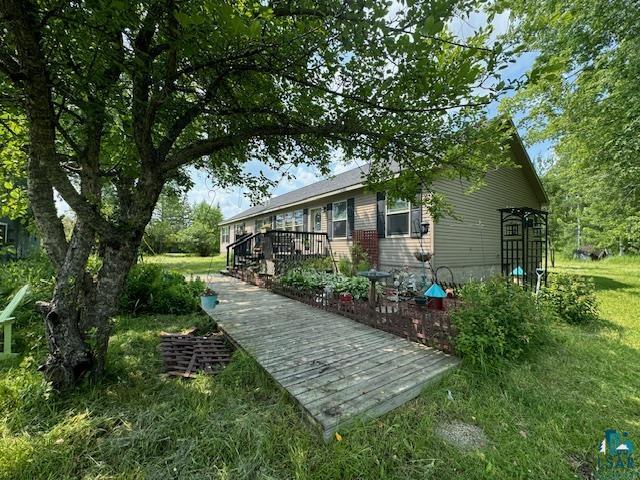 9015 Arkola Road Cotton, MN 55724 - Photo 1 of 21 Back of house featuring a deck and a yard