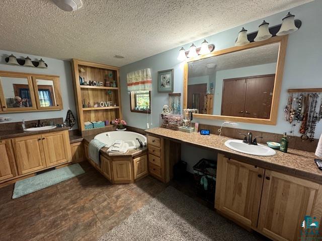 9015 Arkola Road Cotton, MN 55724 - Photo 12 of 21 Bathroom with a textured ceiling, tile patterned floors, vanity, and a bathtub