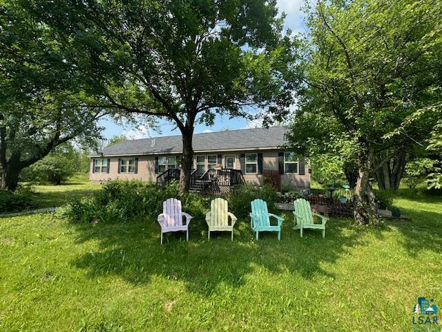 9015 Arkola Road Cotton, MN 55724 - Photo 16 of 21 Rear view of house featuring a yard