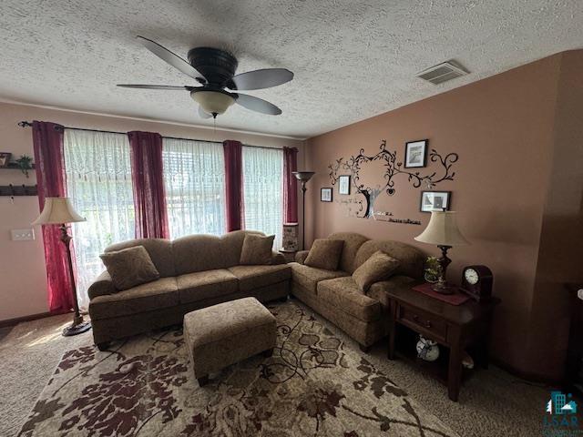9015 Arkola Road Cotton, MN 55724 - Photo 2 of 21 Carpeted living room featuring a textured ceiling and ceiling fan