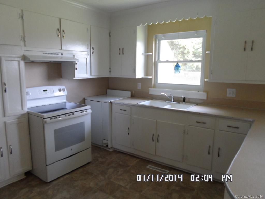 2175 Triplett Road Mooresville, NC 28115 - Photo 3 of 6 a kitchen with cabinets appliances a sink and a window
