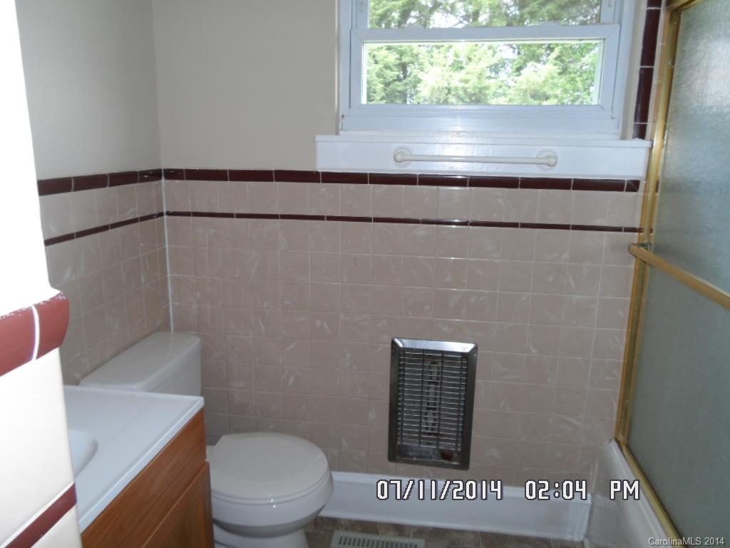 2175 Triplett Road Mooresville, NC 28115 - Photo 4 of 6 a bathroom with a toilet and a shower