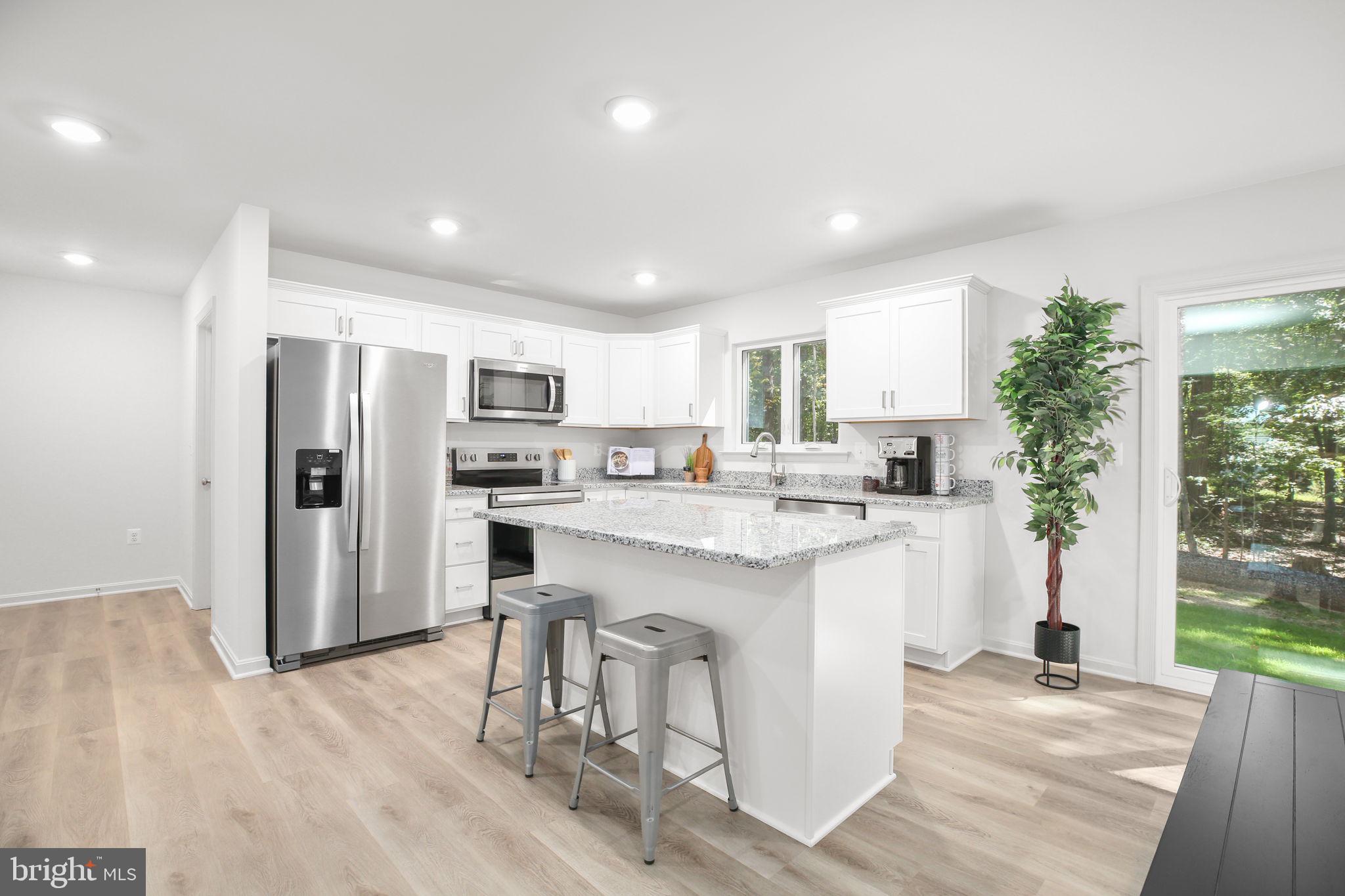 5 Indiantown Road King George, VA 22485 - Photo 2 of 18 a kitchen with stainless steel appliances granite countertop a refrigerator and a stove top oven