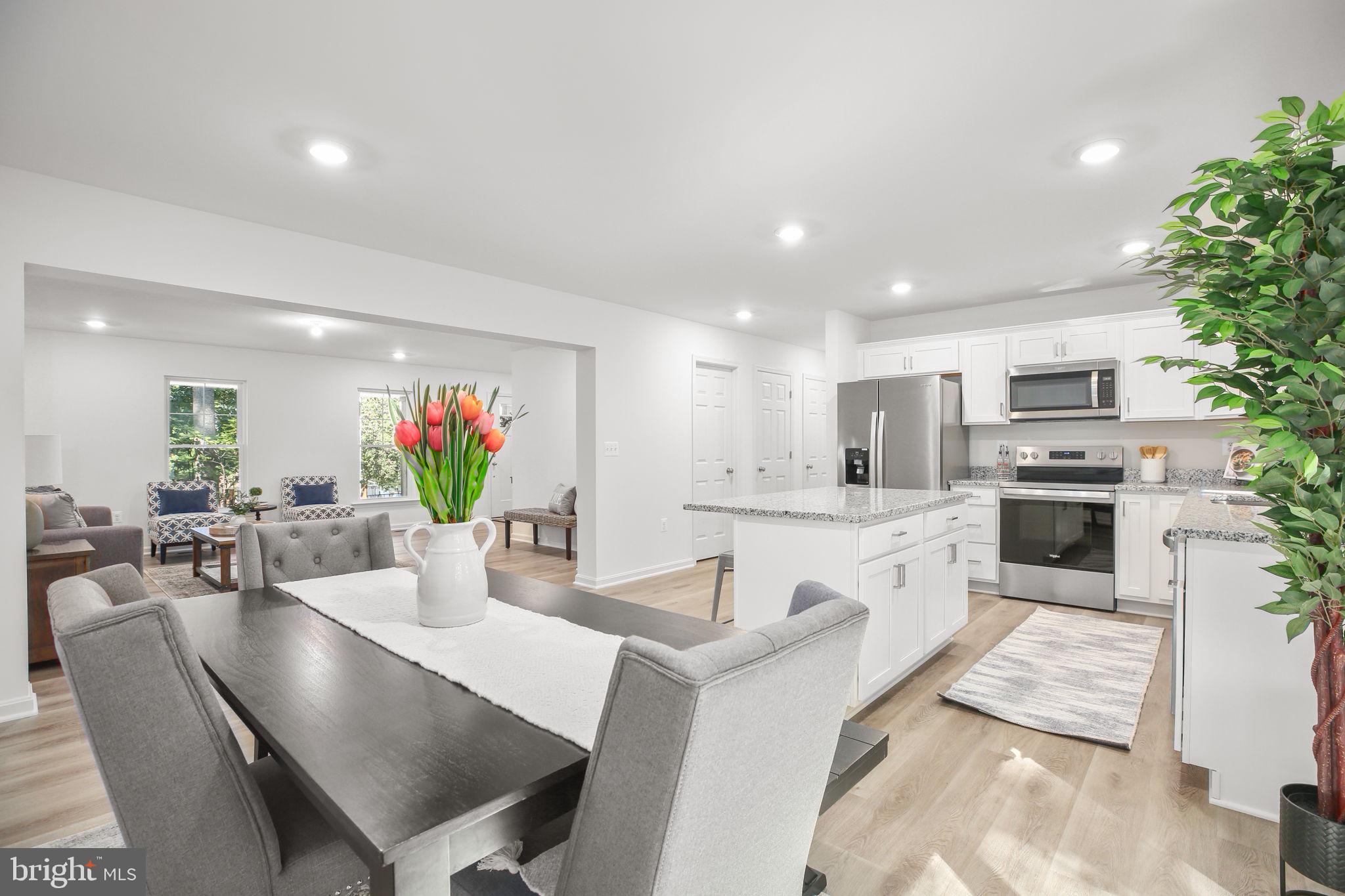 5 Indiantown Road King George, VA 22485 - Photo 7 of 18 a large white kitchen with white cabinets a couches and chairs