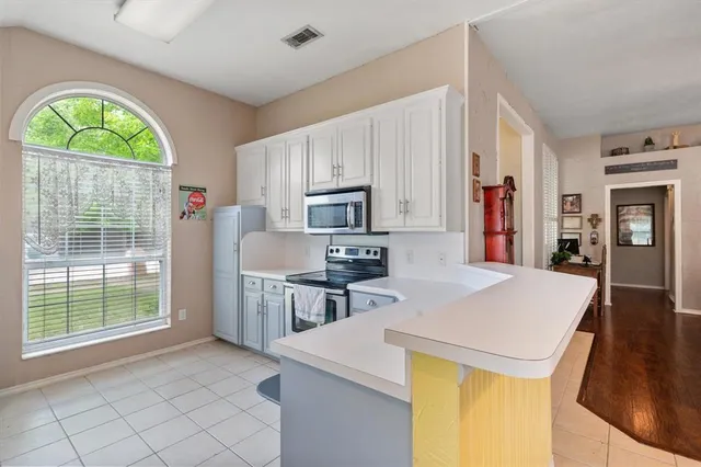 a kitchen with stainless steel appliances a stove a sink and a refrigerator