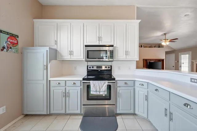 a kitchen with cabinets stainless steel appliances and a counter space