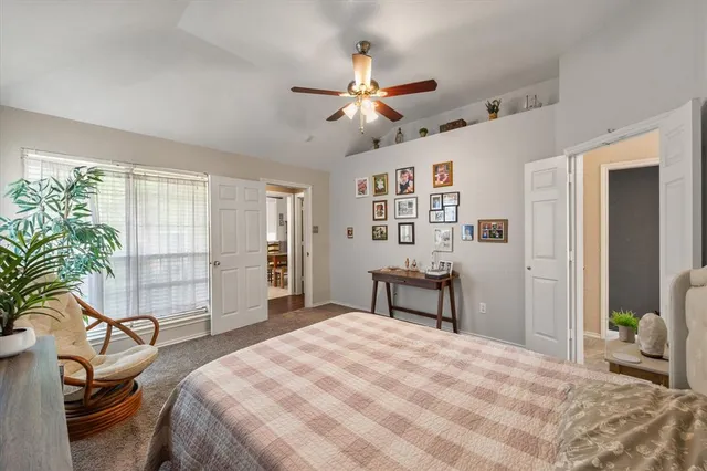 a bedroom with a bed and a dresser next to a window